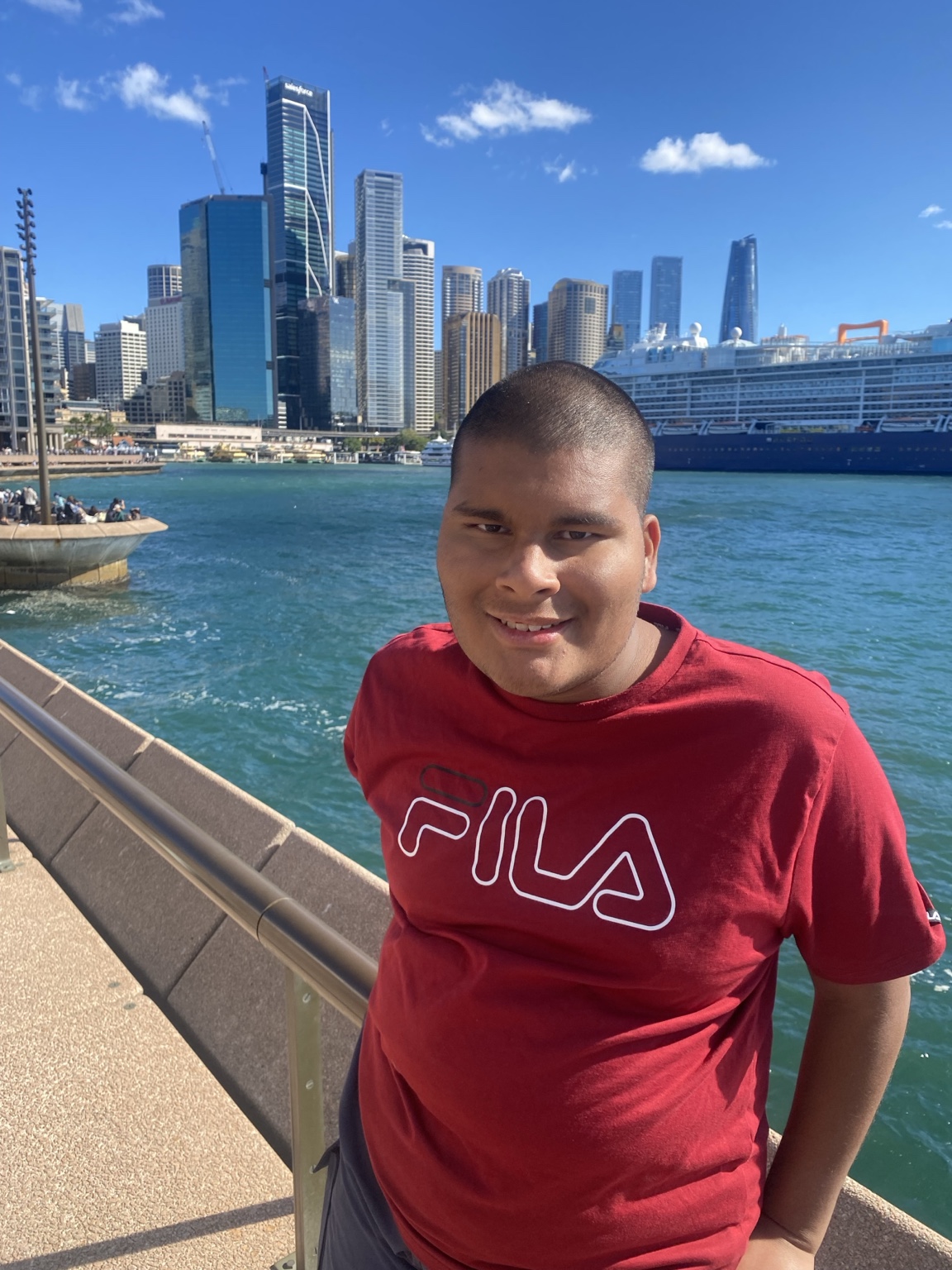 Adam smiling near Sydney Harbour